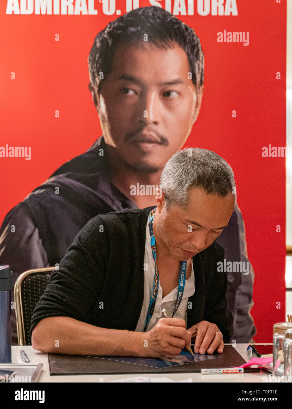 Bonn, Germany - June 8 2019: Ken Leung (*1970, American actor - Star Wars, LOST) signing autographs for fans at FedCon 28, a four day sci-fi convention. FedCon 28 took place Jun 7-10 2019. Stock Photo
