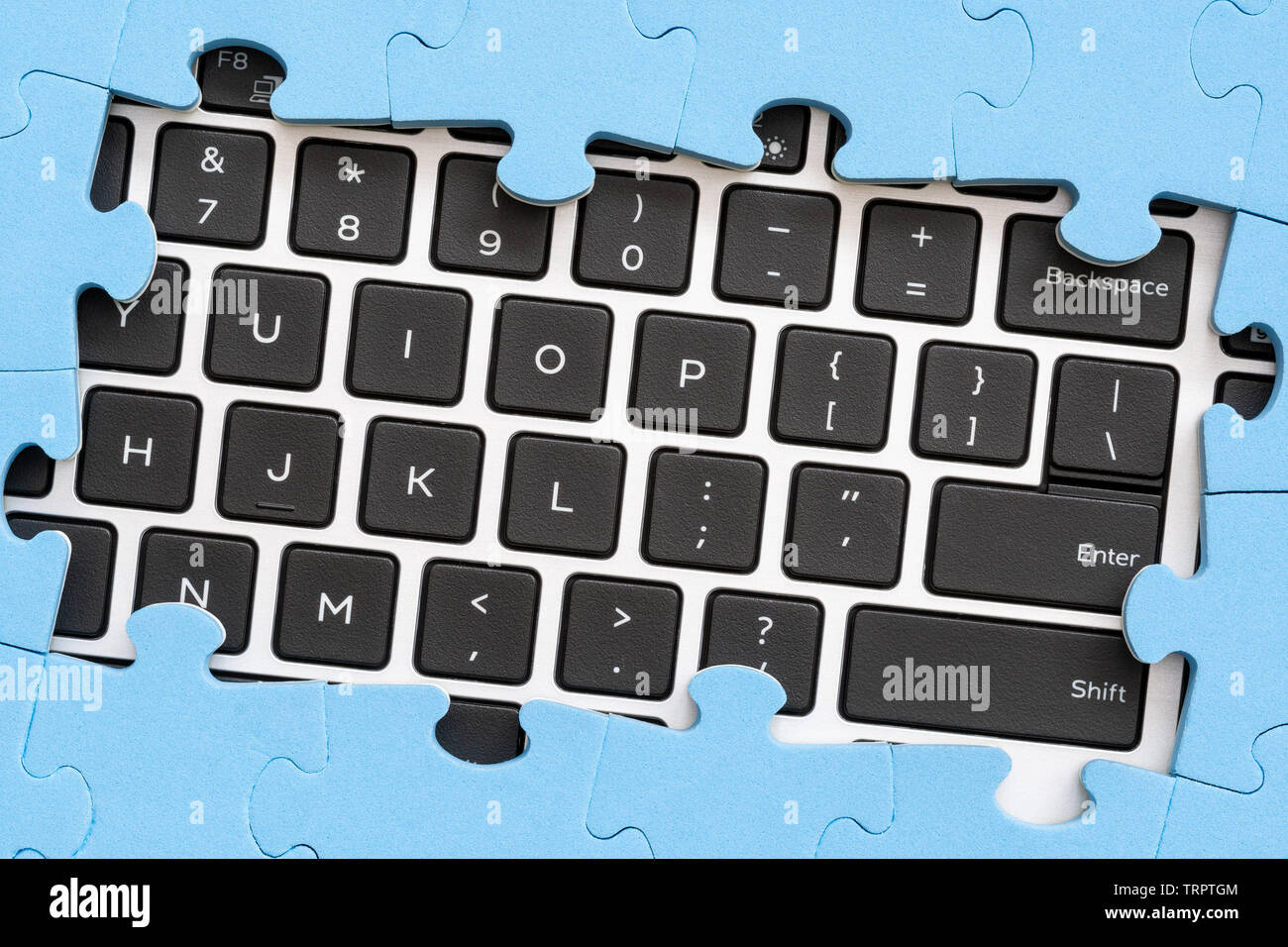 Computer keyboard with frame from jigsaw puzzle . Computer problems