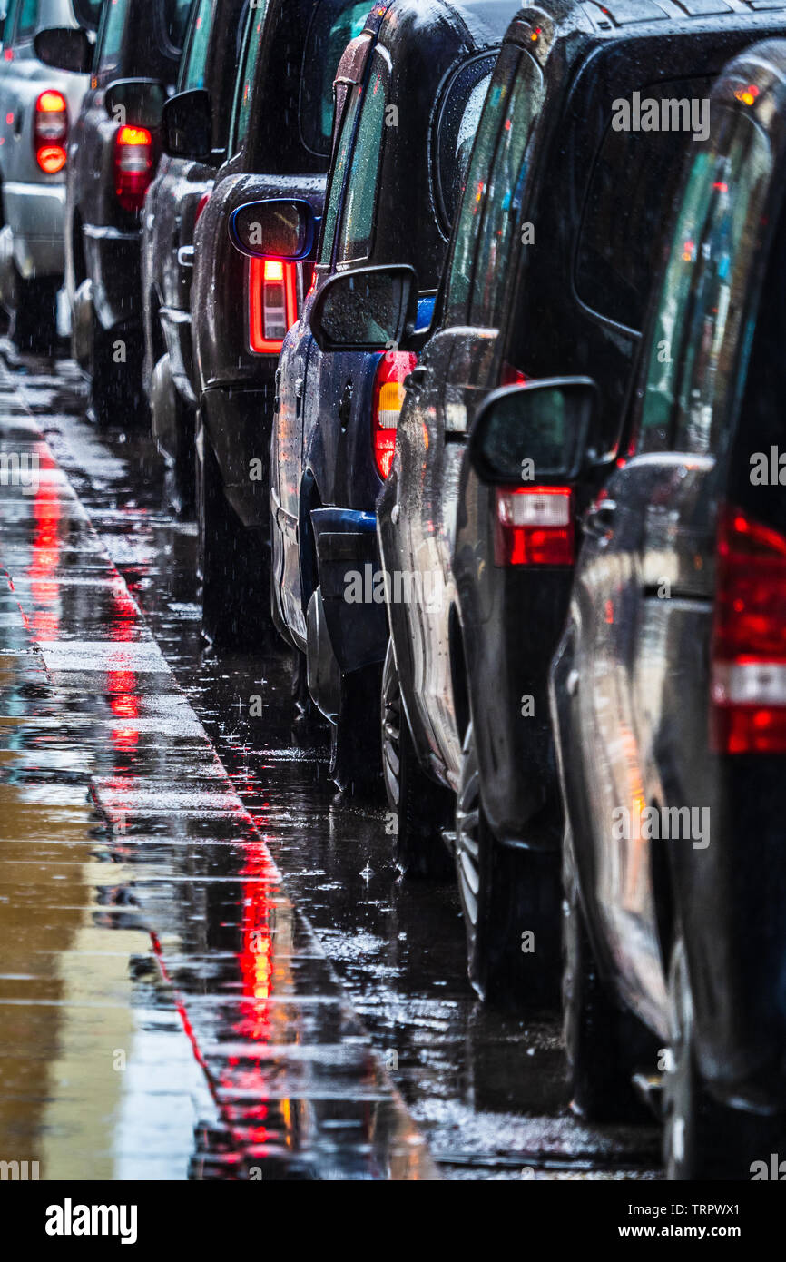 London Taxis in the Rain - a queue of London Black Cabs waiting for passengers in the pouring rain Stock Photo