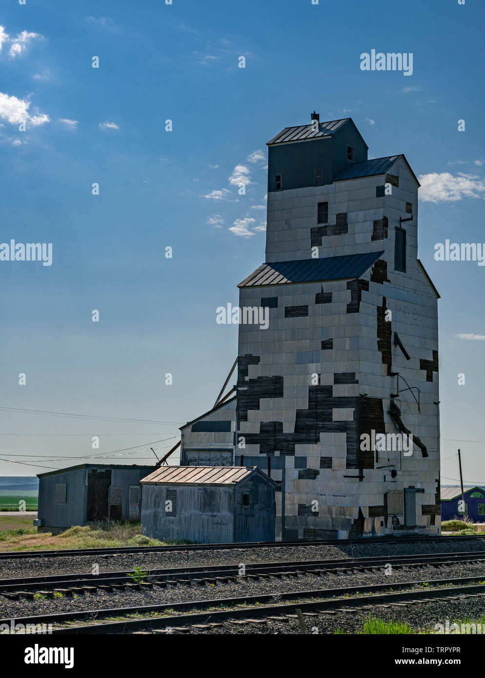 A decaying grain elevator along the former Milwaukee Road tracks in