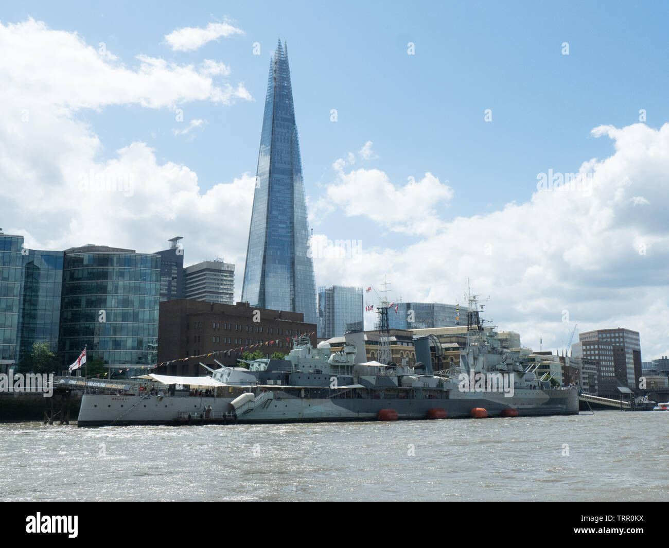 HMS Belfast on the River Thames, seen from the river at high tide Stock Photo