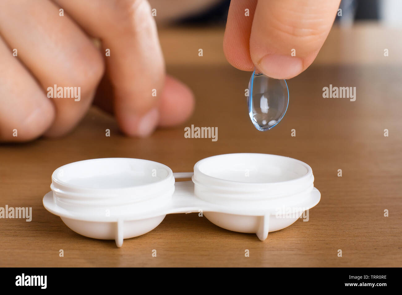 hand of woman holding contact lens, closeup Stock Photo