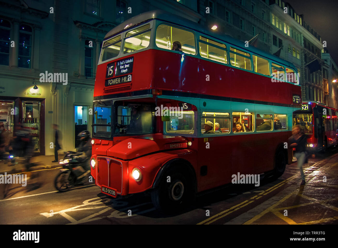 Vintage red double decker bus in a night street of London, UK. Stock Photo