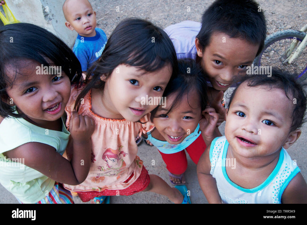 A group of children from the town of the island of Coron, Palawan  pose for a tourist and playfully ask their photos to be taken. Stock Photo