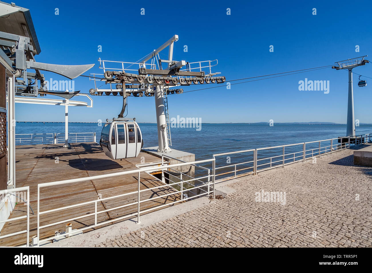 Lisbon, Portugal. Aerial Tramway leaving or entering terminal aka embarking or docking station, Parque das Nacoes aka Nations Park with Tagus River Stock Photo