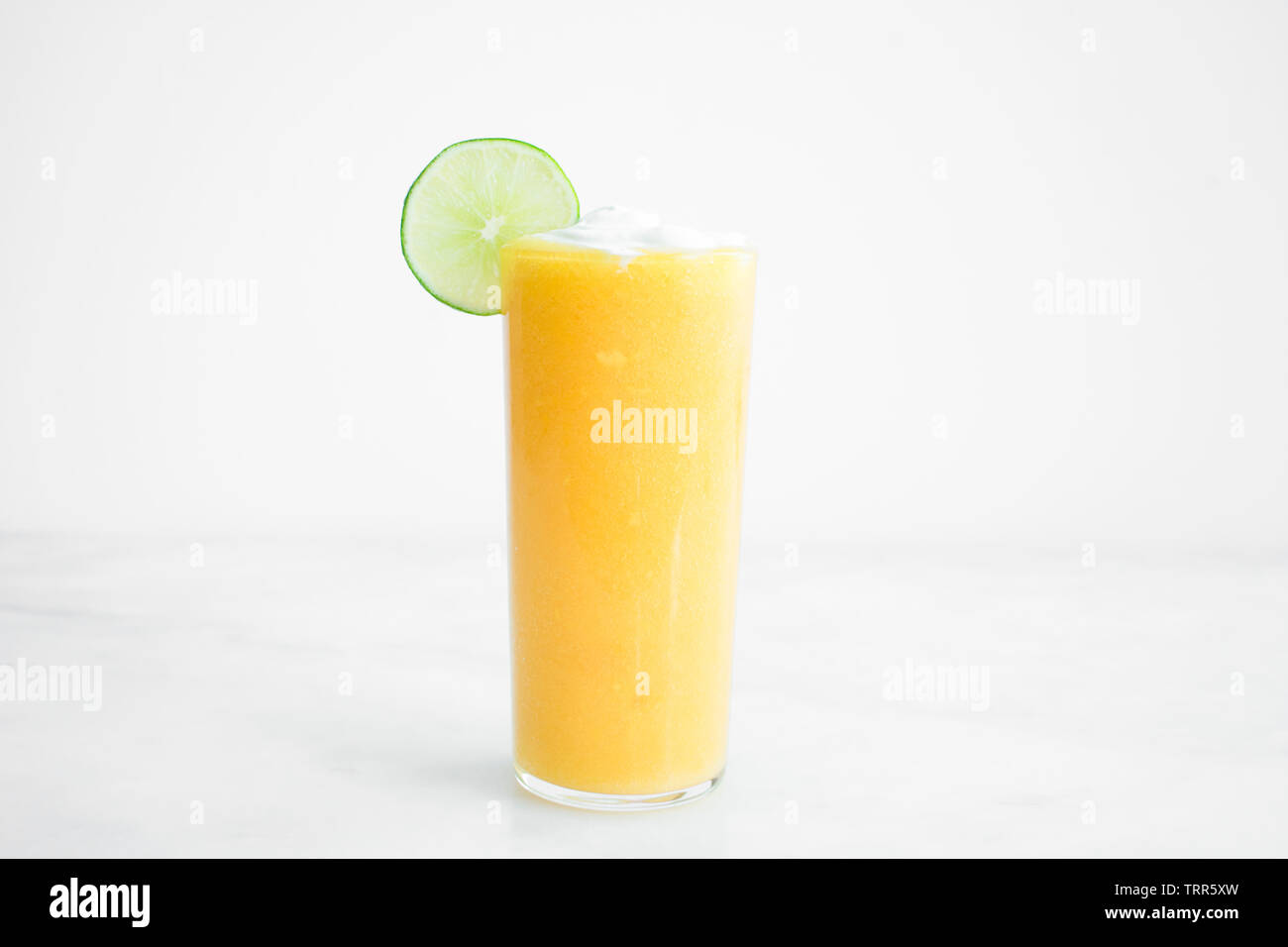 Mango Coconut Cocktail with a Lime Garnish Stock Photo