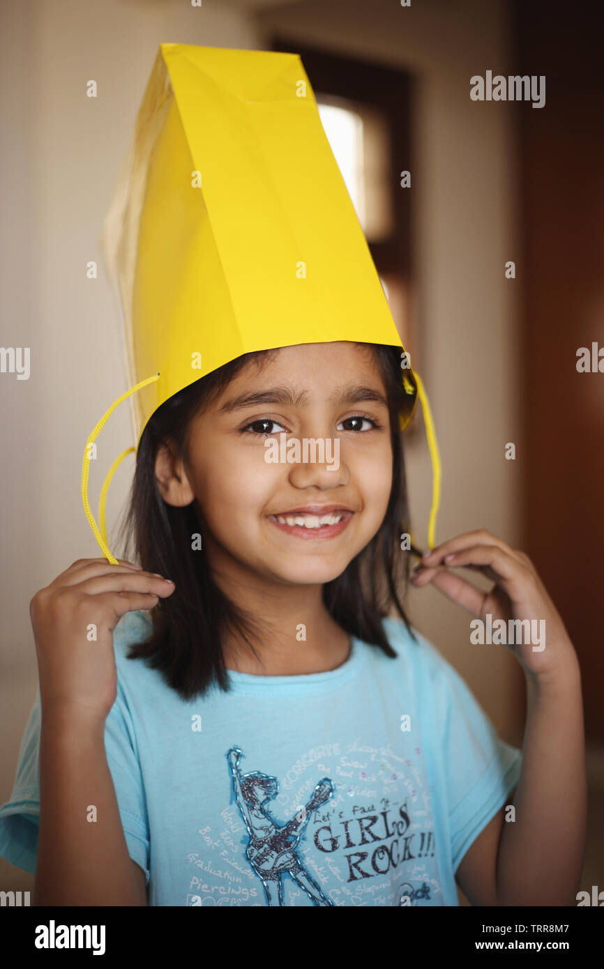 Girl wearing a paper bag and smiling Stock Photo Alamy