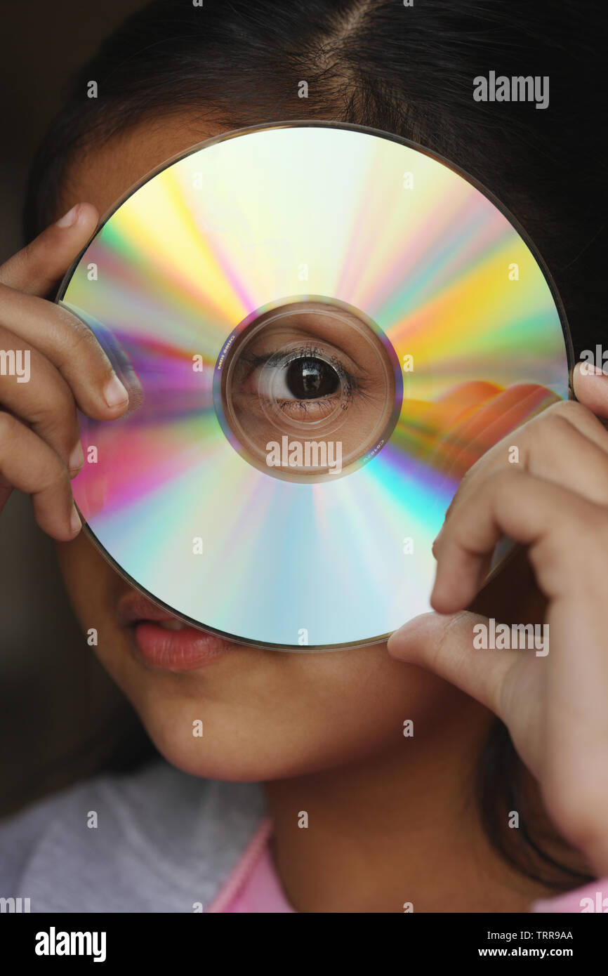 Girl looking through a compact disc center Stock Photo Alamy