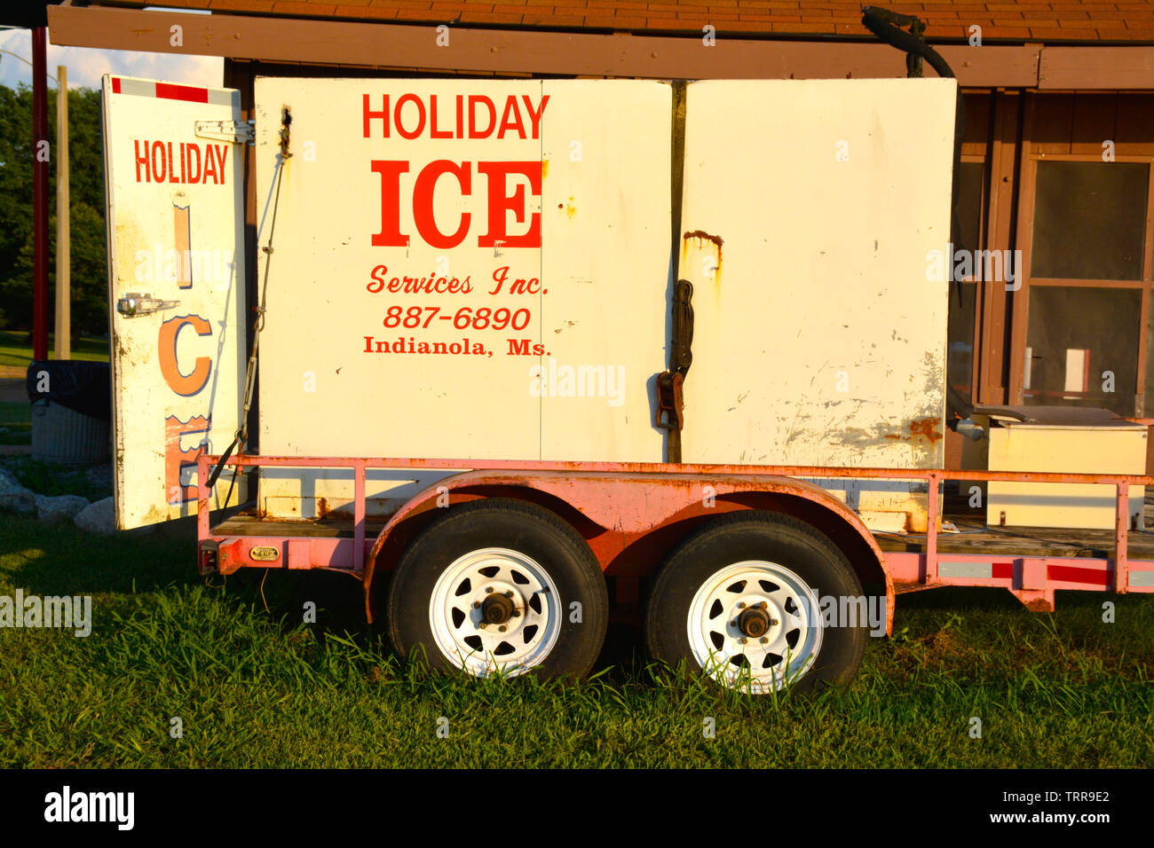 A vintage red and white trailer for the Holiday Ice Company in Indianola, MS, at sundown in Northern Mississippi Stock Photo