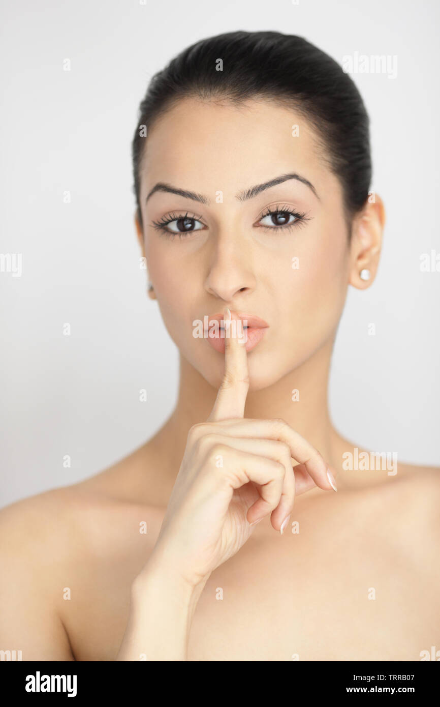 Portrait of an Indian young woman with a finger on lips Stock Photo - Alamy