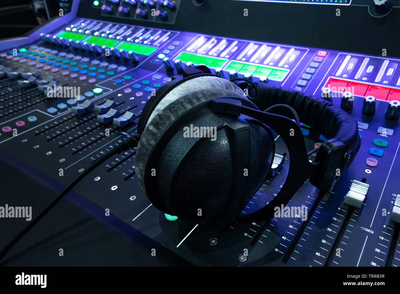 Professional audio studio sound mixer console board panel with recording ,  headphone and adjusting knobs,TV equipment. Blue tone and close-up image wi  Stock Photo - Alamy