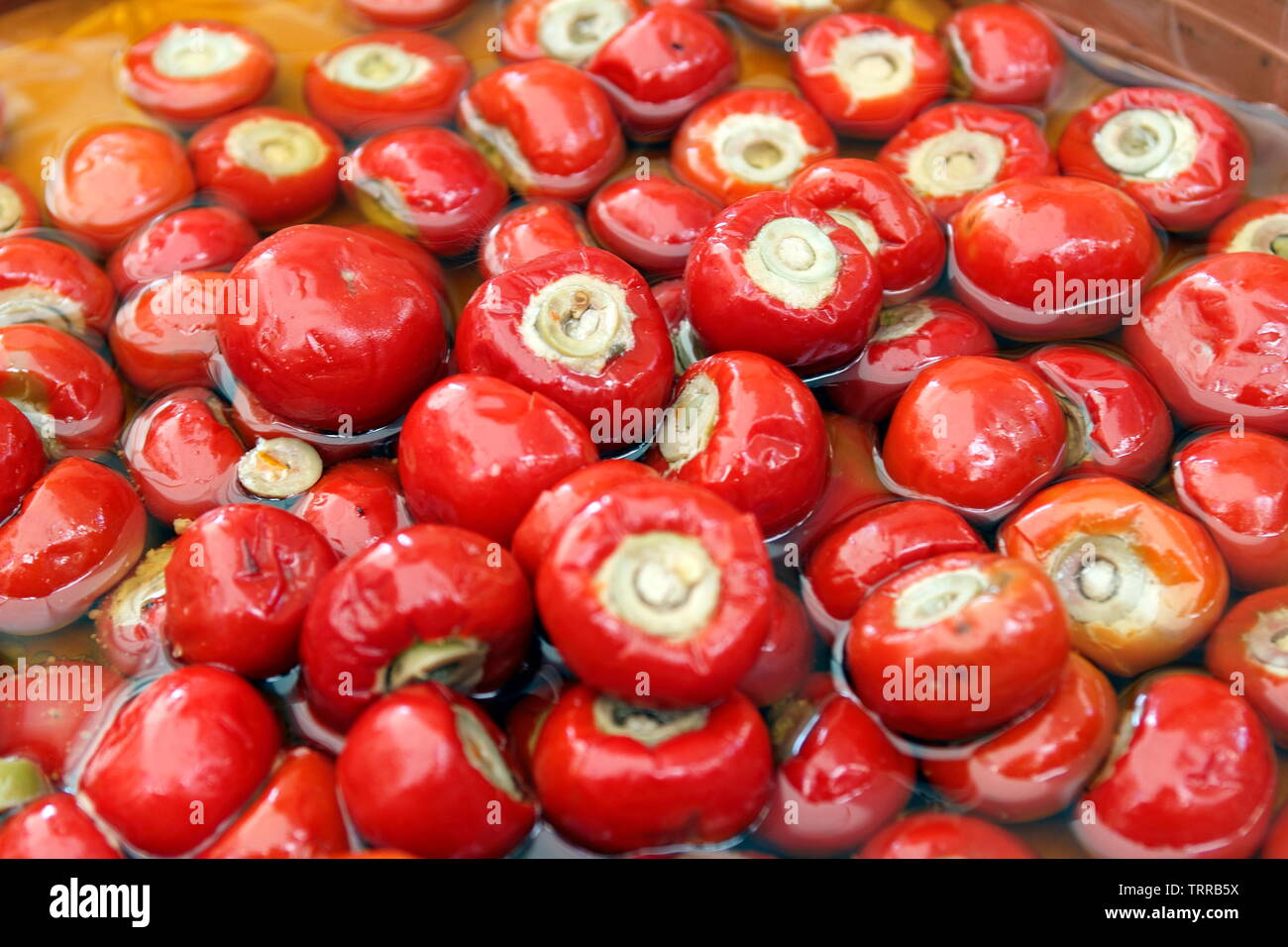 Italy Piedmont lakes area Orta San Giulio Lago d' Giulio Italian Alps red cherry peppers and olives for sale in Wednesday market Stock Photo