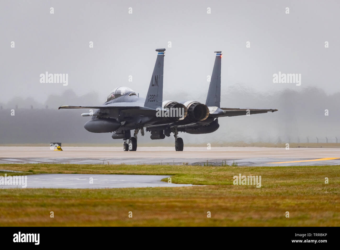 A USAF F-15 taxis at the end of the runway at RAF Lakenheath, Suffolk, UK. Stock Photo
