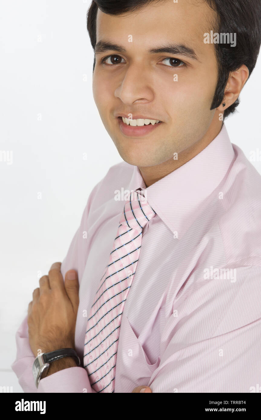 Businessman smiling with his arms crossed Stock Photo - Alamy