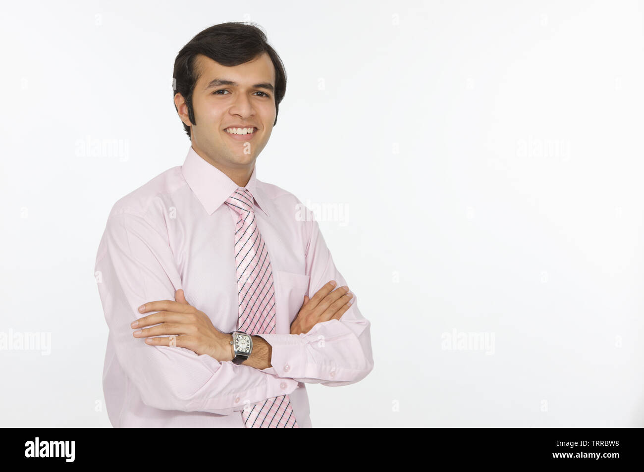 Businessman smiling with his arms crossed Stock Photo - Alamy