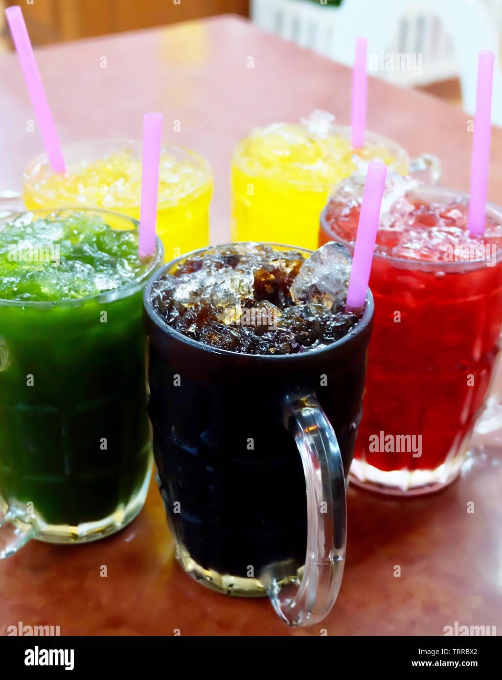 Fresh Thai Iced Black Coffee, Gotu Kola Juice with Chrysanthemum and RoselleIced Iced Tea on Table. Stock Photo