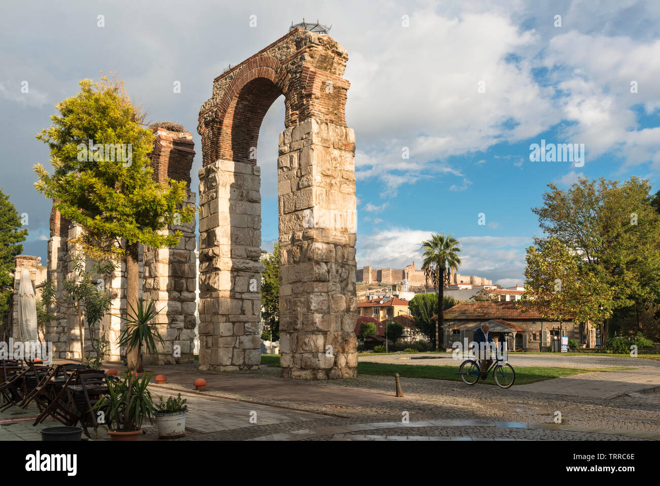 Early morning sunlight on arches of the Byzantine aqueduct in the centre of Selcuk and in the background Selcuk Castle (aka Ayasoluk Castle or Ayasulu Stock Photo