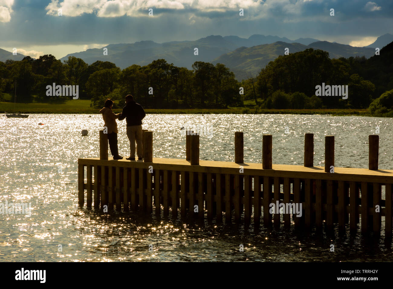 Tourists on a pier on Lake Windermere, Ambleside, Cumbria, UK Stock Photo