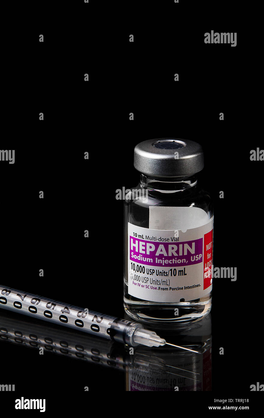 A bottle of the anticoagulant drug Heparin Sodium with a Syringe on a