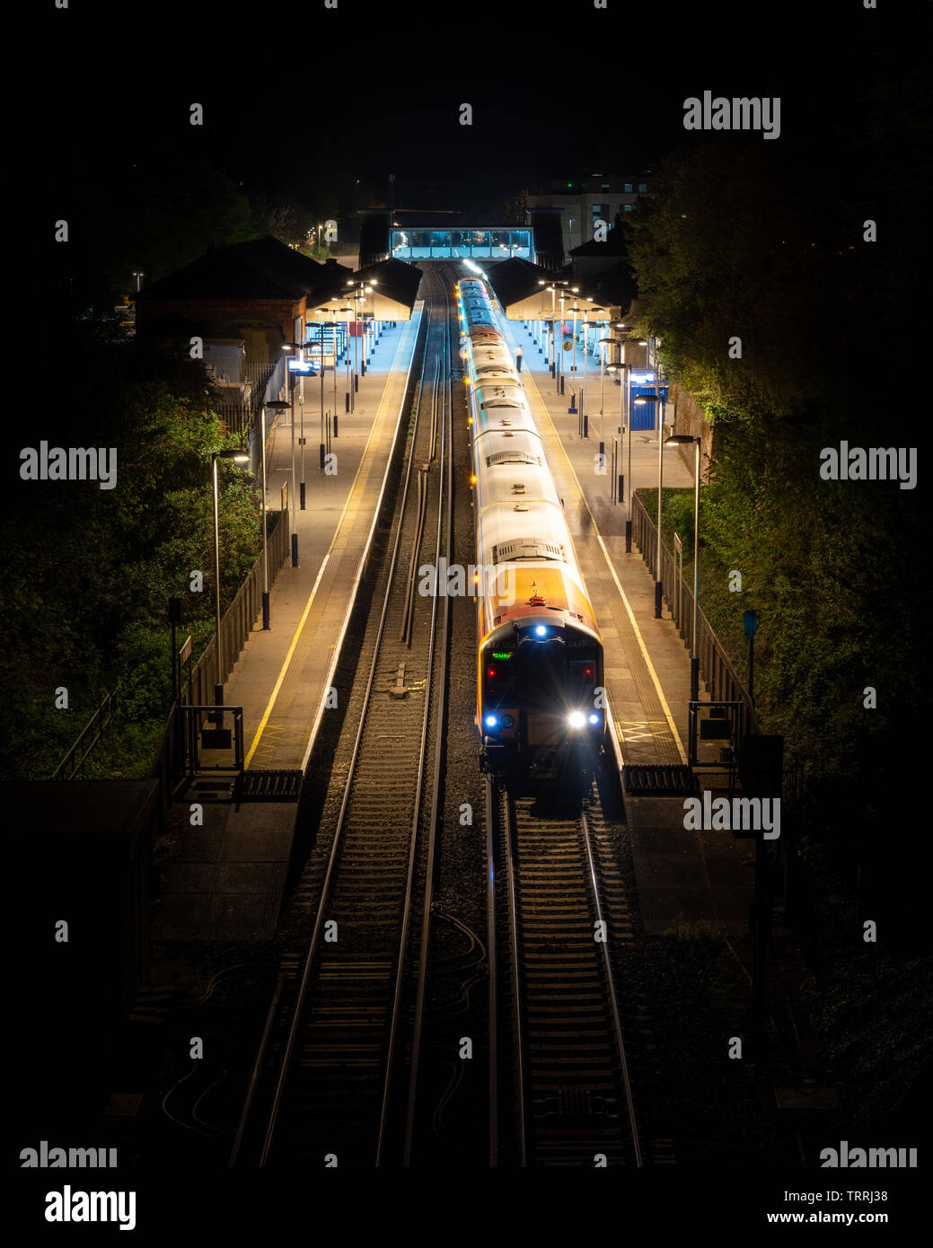 Winchester, England, UK - April 22, 2019: A South Western Railway passenger train calls at Winchester Railway Station in Hampshire at night. Stock Photo
