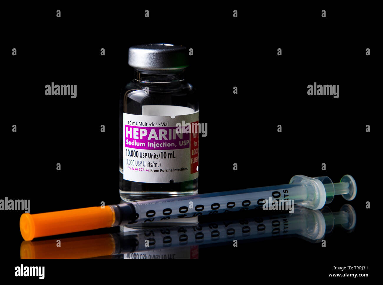 A bottle of the anticoagulant drug Heparin Sodium with a Syringe on a
