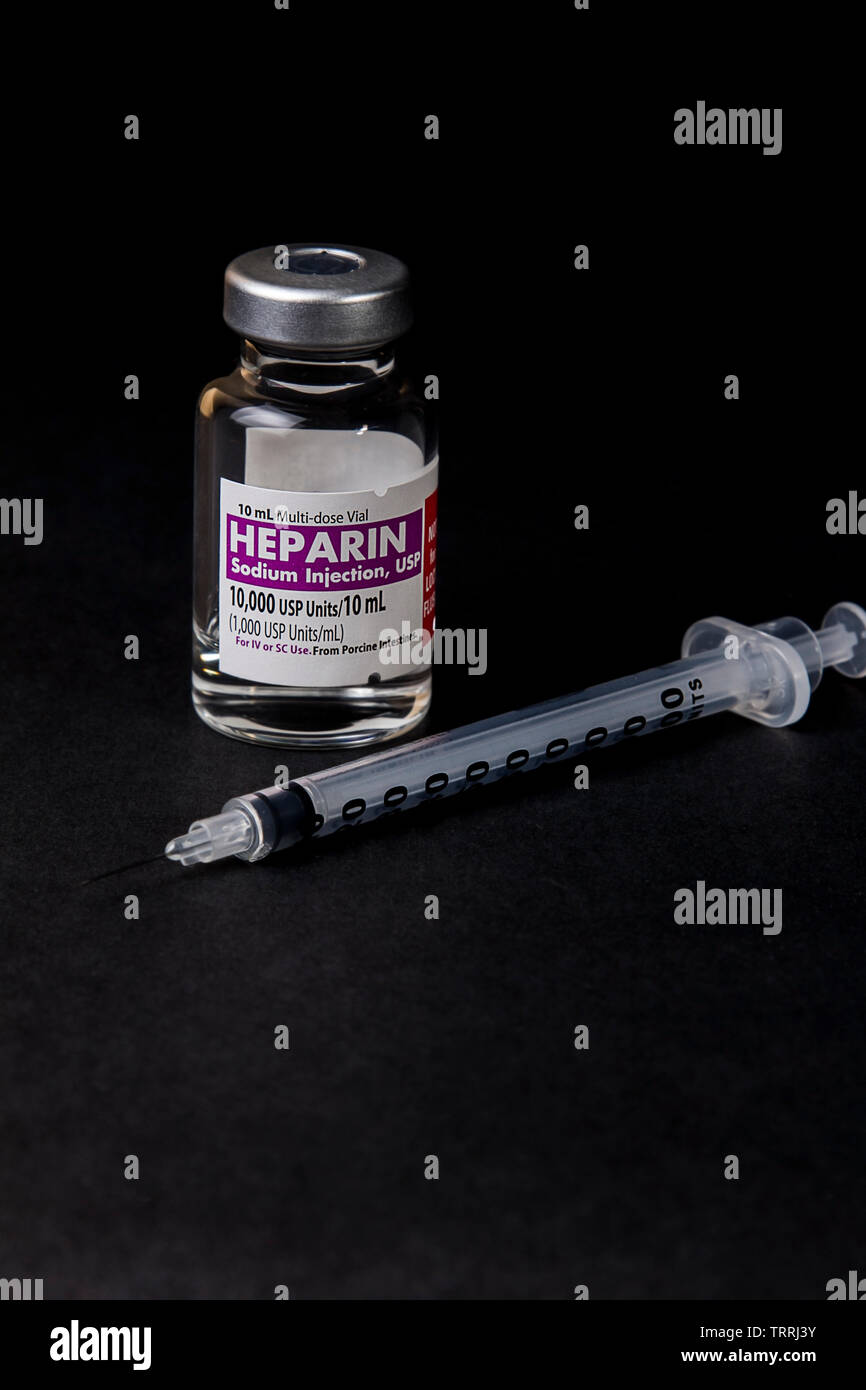 A bottle of the anticoagulant drug Heparin Sodium with a Syringe on a