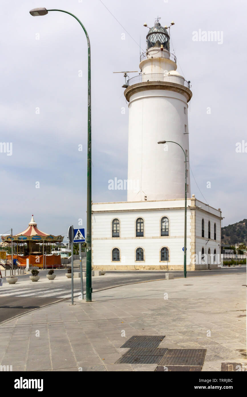 La Farola, Malaga, Spain - Circa 2015.  Well-known lighthouse surrounded by eateries, walking trails & serene water views. Stock Photo