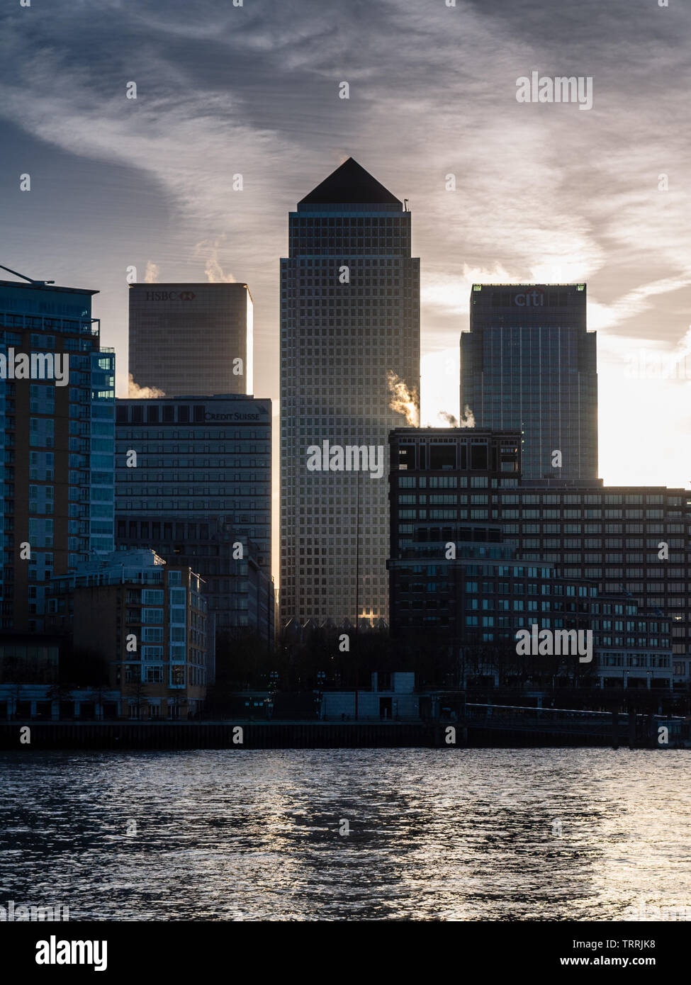 London, England, UK - March 11, 2011: Skyscrapers of the Canary Wharf business district are silhouetted against the sunrise in East London. Stock Photo