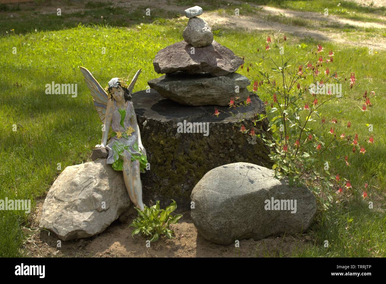 A Fairy Watches Over Her Small Garden Area Stock Photo