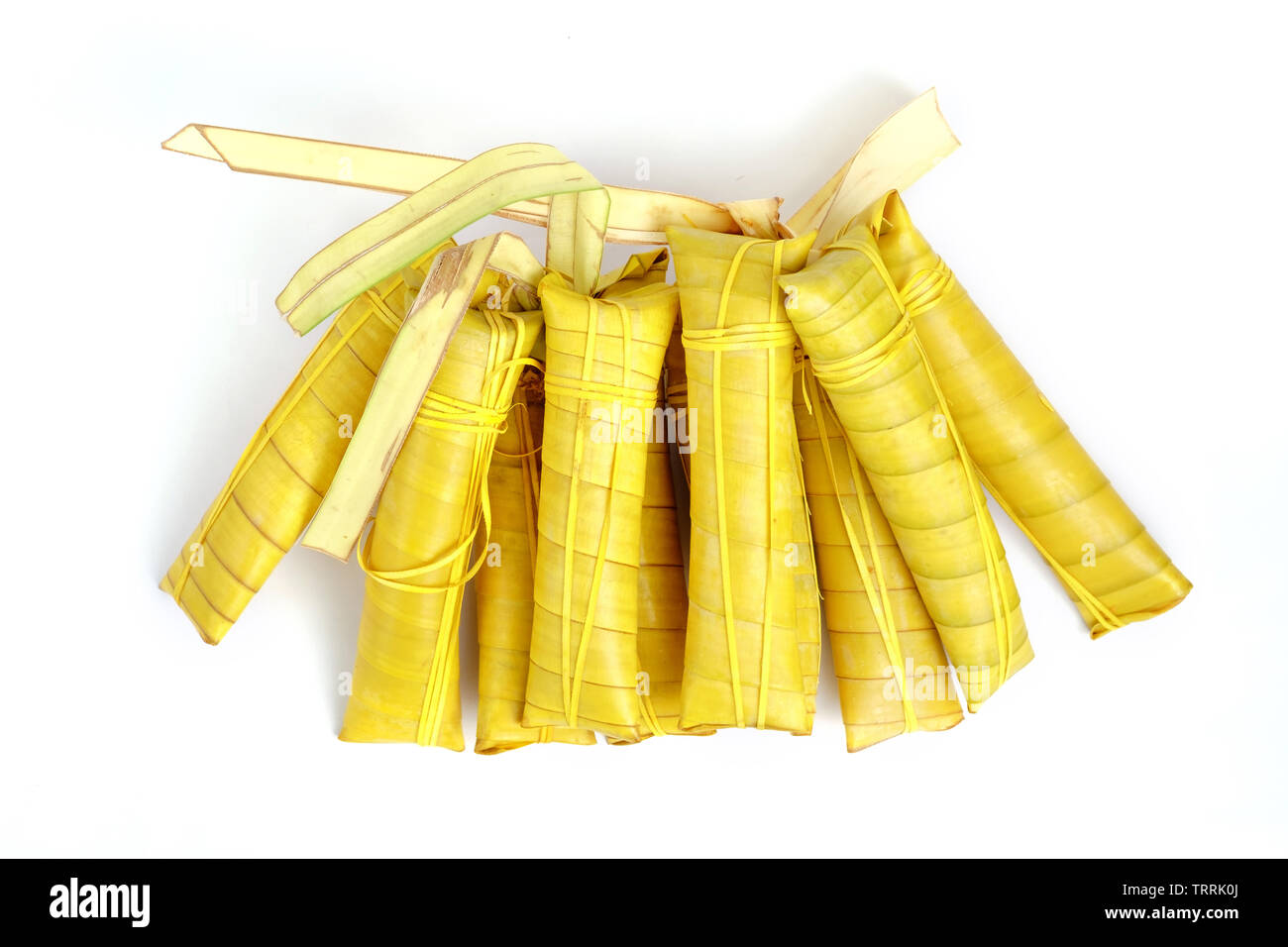 Suman sa Ibos, a traditional sticky rice cake wrapped in buli leaves on white background Stock Photo