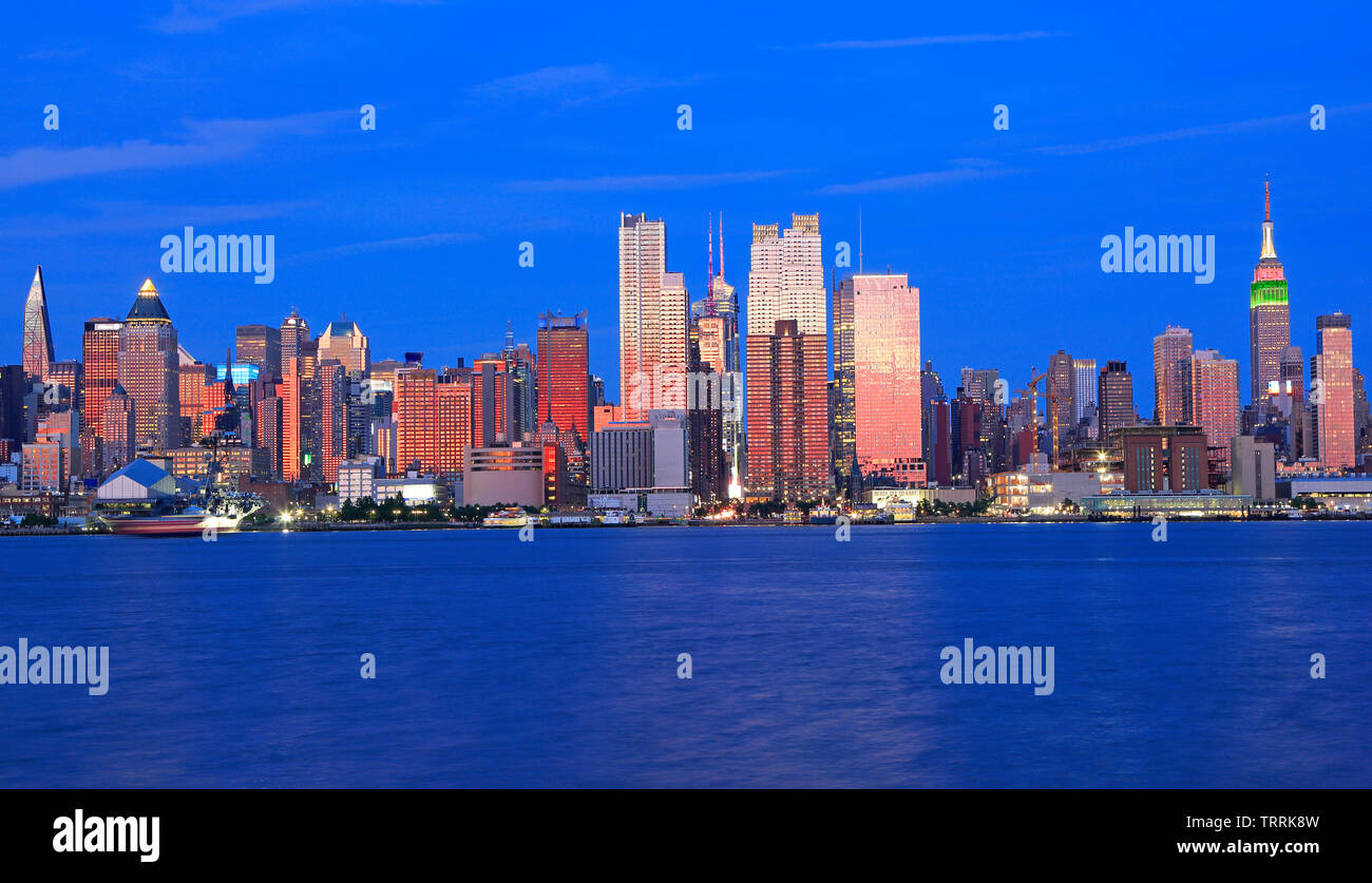 New York City skyline at dusk reflected in Hudson River, USA Stock ...