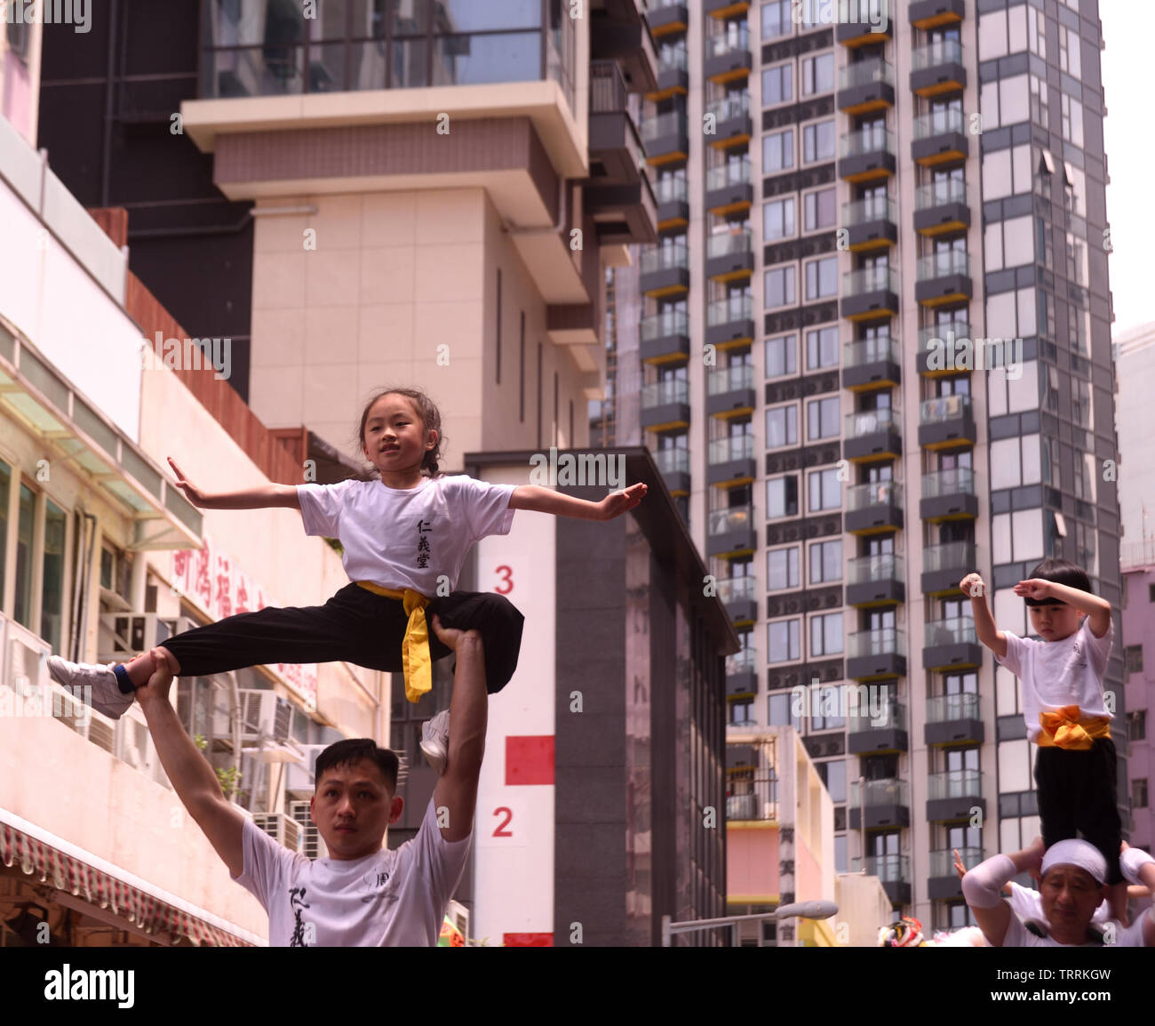 Kids showing Kung Fu posture  in the annual celebration parade of Tam Kung Festival  in Hong Kong Stock Photo