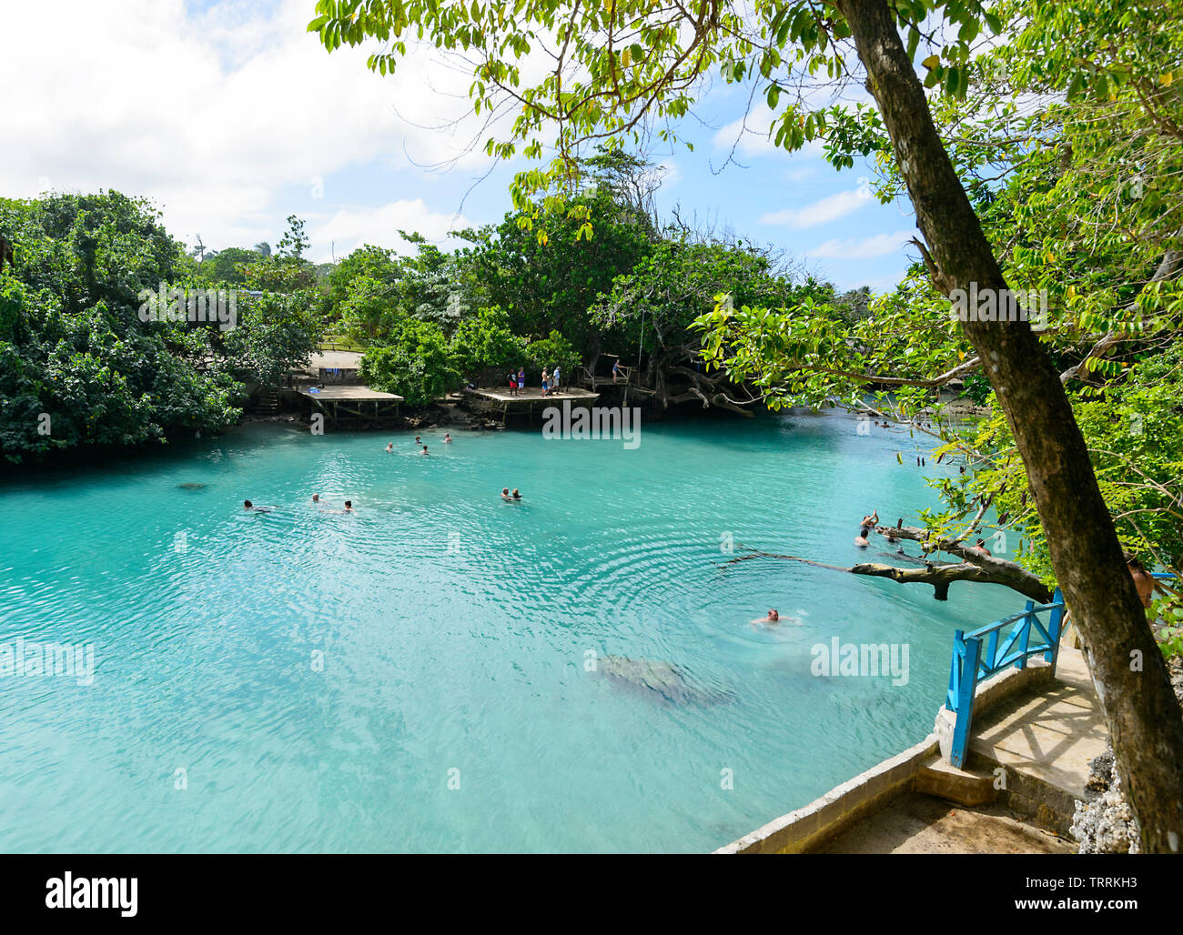 People swimming in Blue Lagoon, a popular scenic turquoise swimming hole near Port Vila, Efate Island, Vanuatu, Melanesia Stock Photo