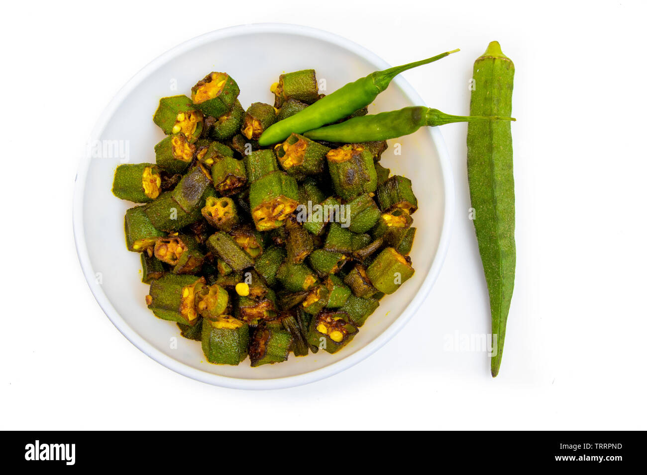 Premium Photo | Okra or ladys finger or bhindi fresh green vegetable  arranged on a white tableware with a bowl full of okra sliced rings with  wooden background selective focus top view