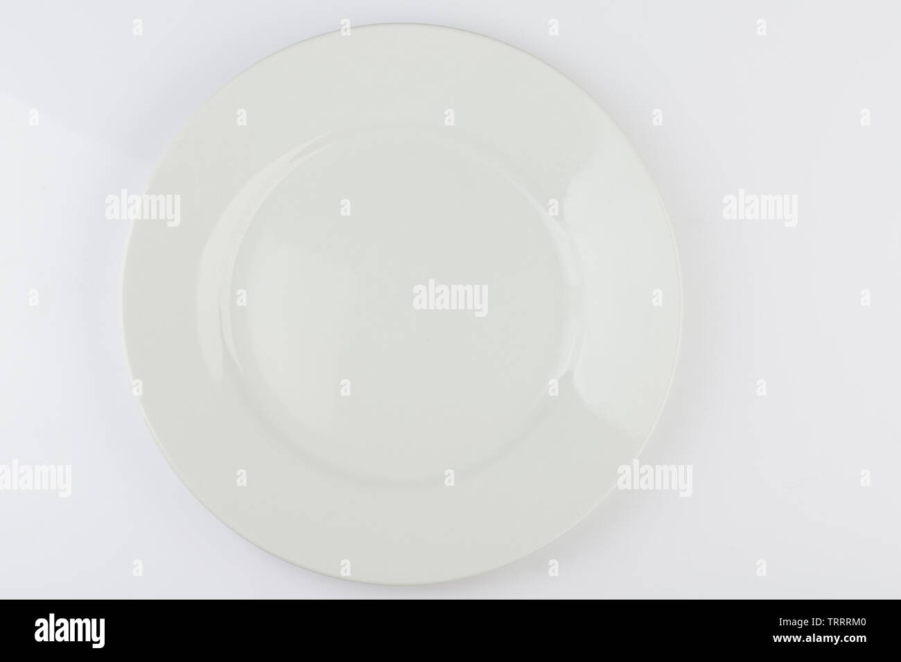 Empty clean round white plate above top view isolated Stock Photo