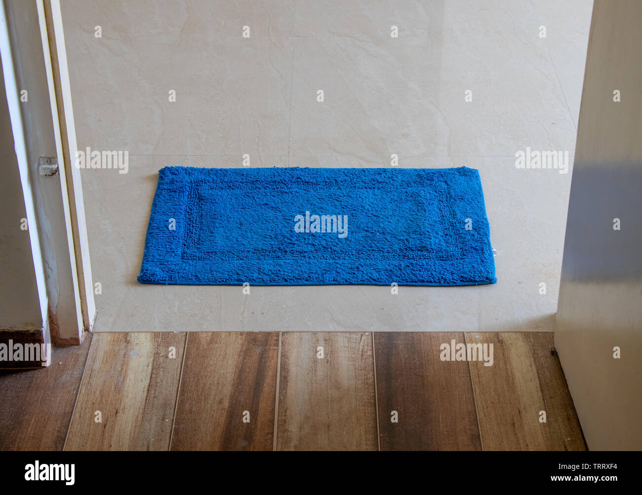 Blue door  mat lying in door Stock Photo