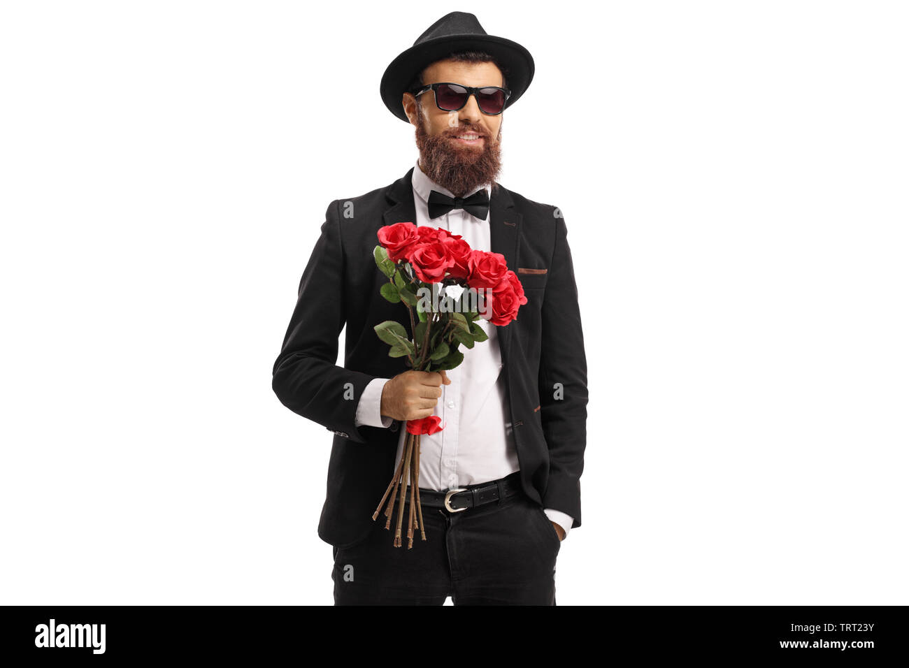 Bearded man in a suit holding a bouquet of red roses isolated on white ...