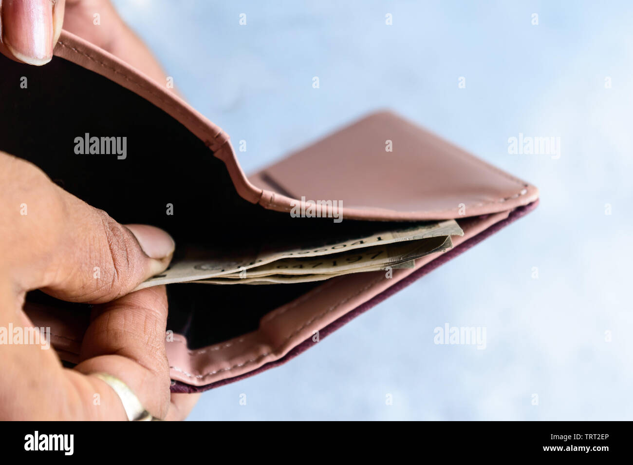 Businessman putting or taking out or paying Indian rupee banknotes from leather wallet. Isolated white background. Earning crisis growth bribe corrupt Stock Photo