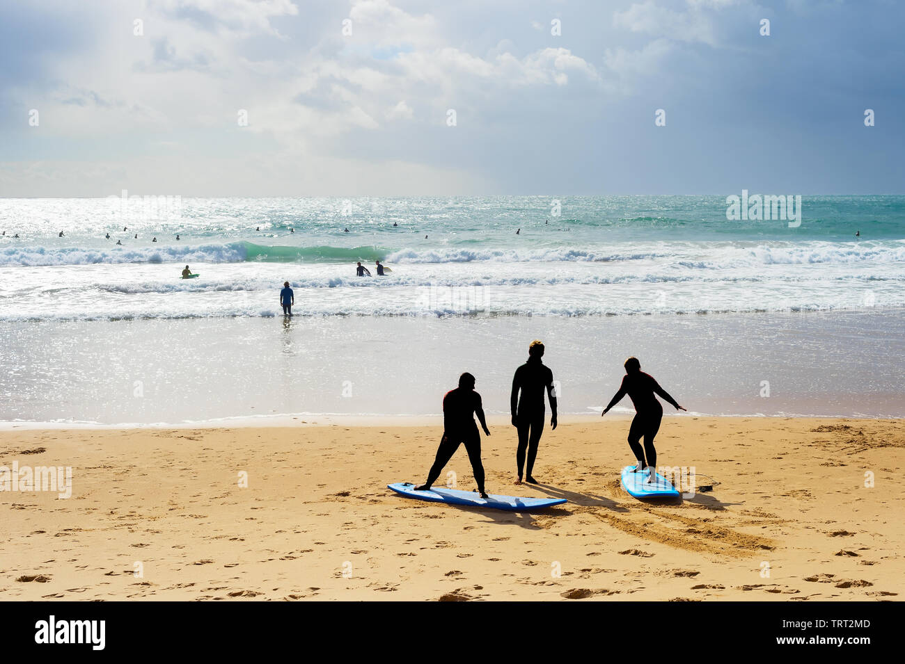 Surfing school learning taking surf lesson at the beach. Portugal Stock Photo