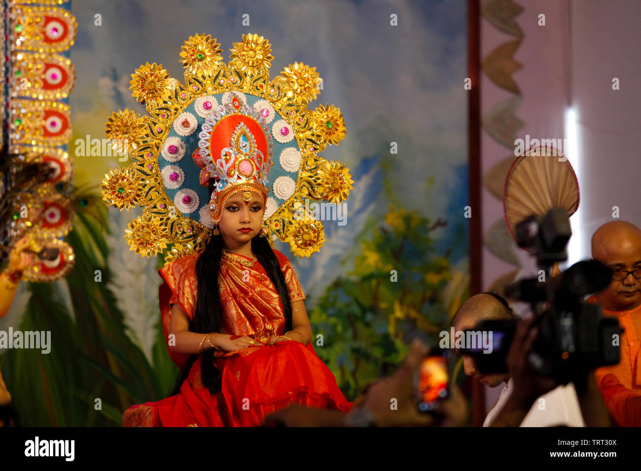 A young girl sits for the 'Kumari Puja' ritual at the Ramkrishna Mission temple in Dhaka. Kumari Puja is a part of Durga Puja festival where a young g Stock Photo