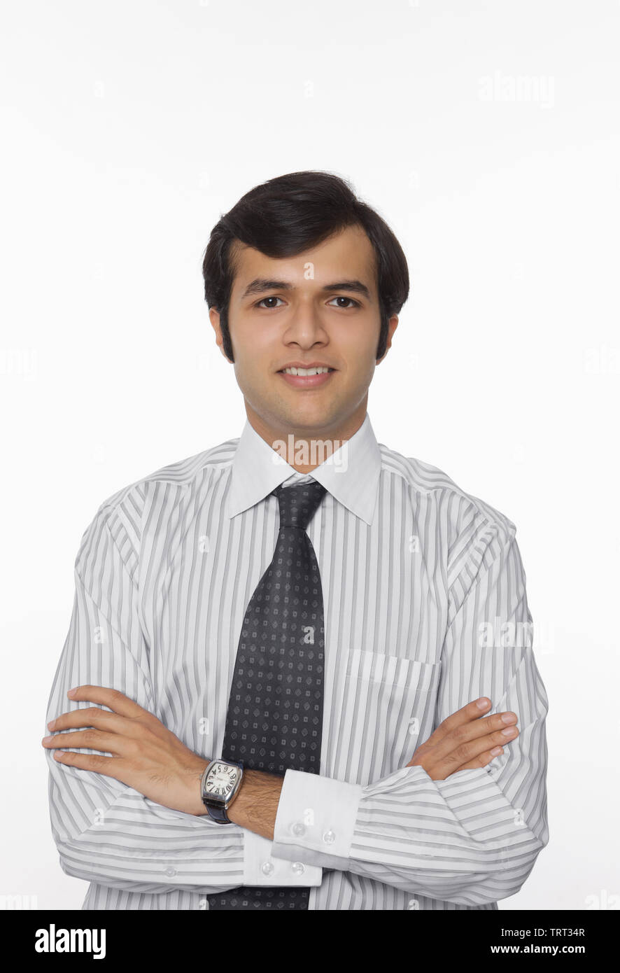 Indian businessman standing with his arms crossed Stock Photo - Alamy