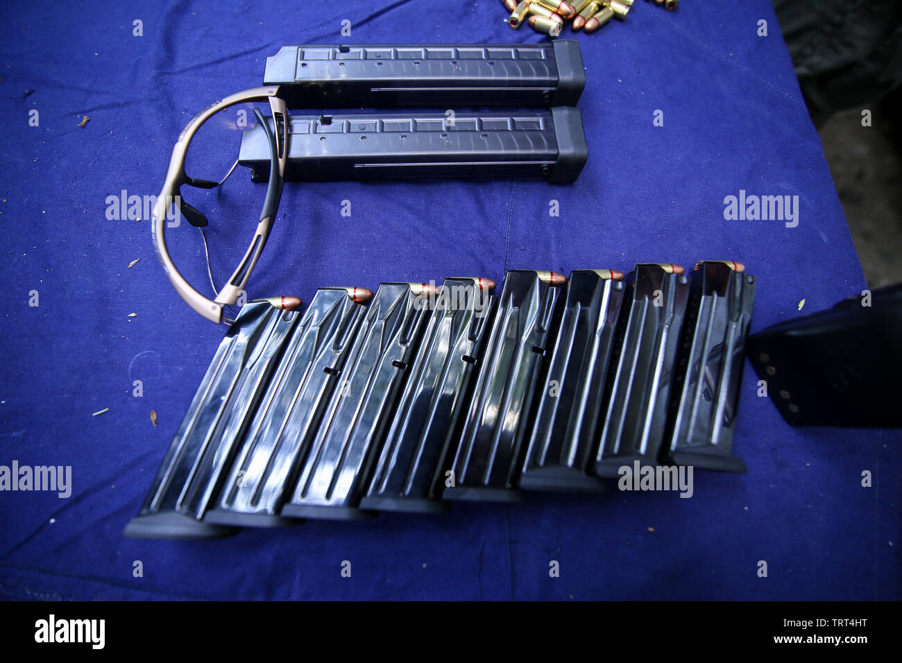 Details with gun clips, 9mm ammunition and protective glasses on a