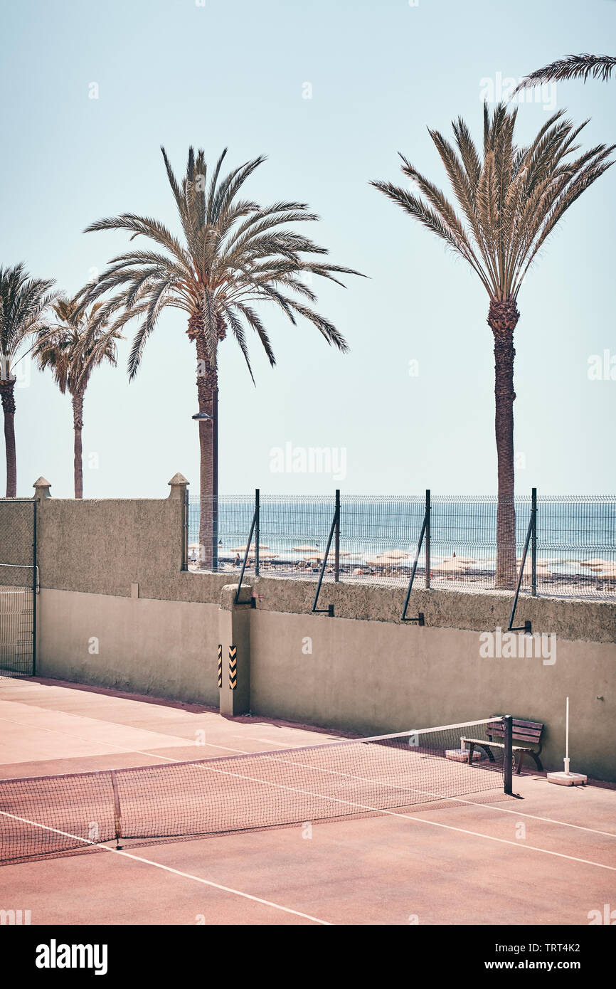 Retro toned picture of a tennis court by a beach, Tenerife, Spain. Stock Photo