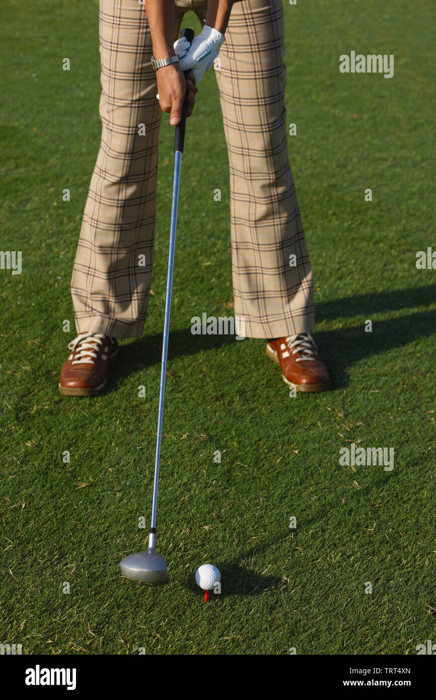 Golfer preparing to putt a golf ball Stock Photo Alamy