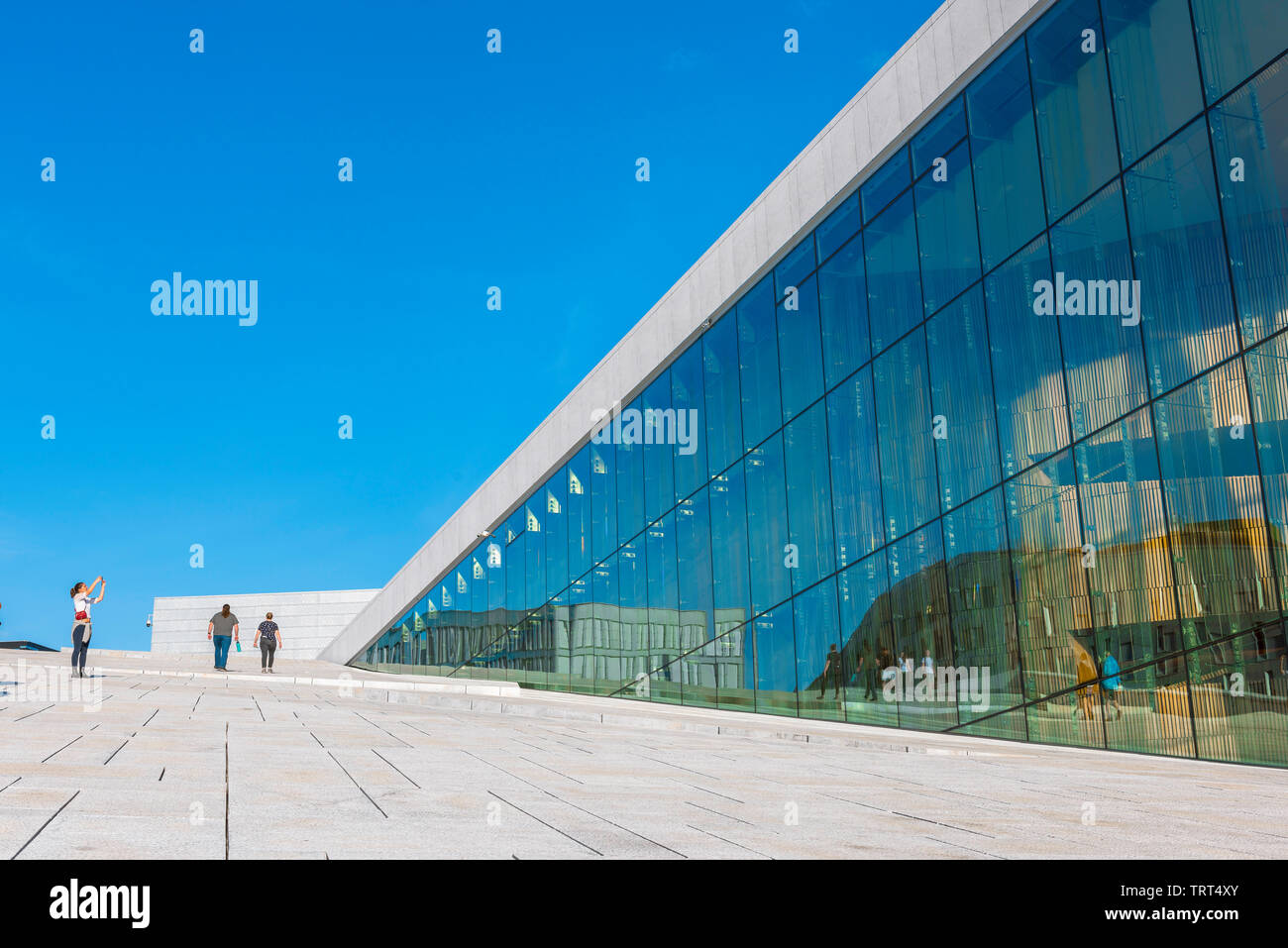 Oslo Opera House, view in summer of a tourist taking a photo on the vast access ramp leading to the roof of the Oslo Opera House, Norway. Stock Photo