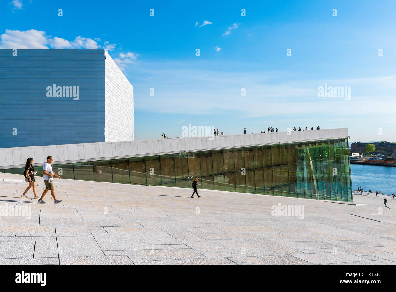 Opera House Oslo, view in summer of people walking on the vast access ramp leading to the roof of the Oslo Opera House. Stock Photo