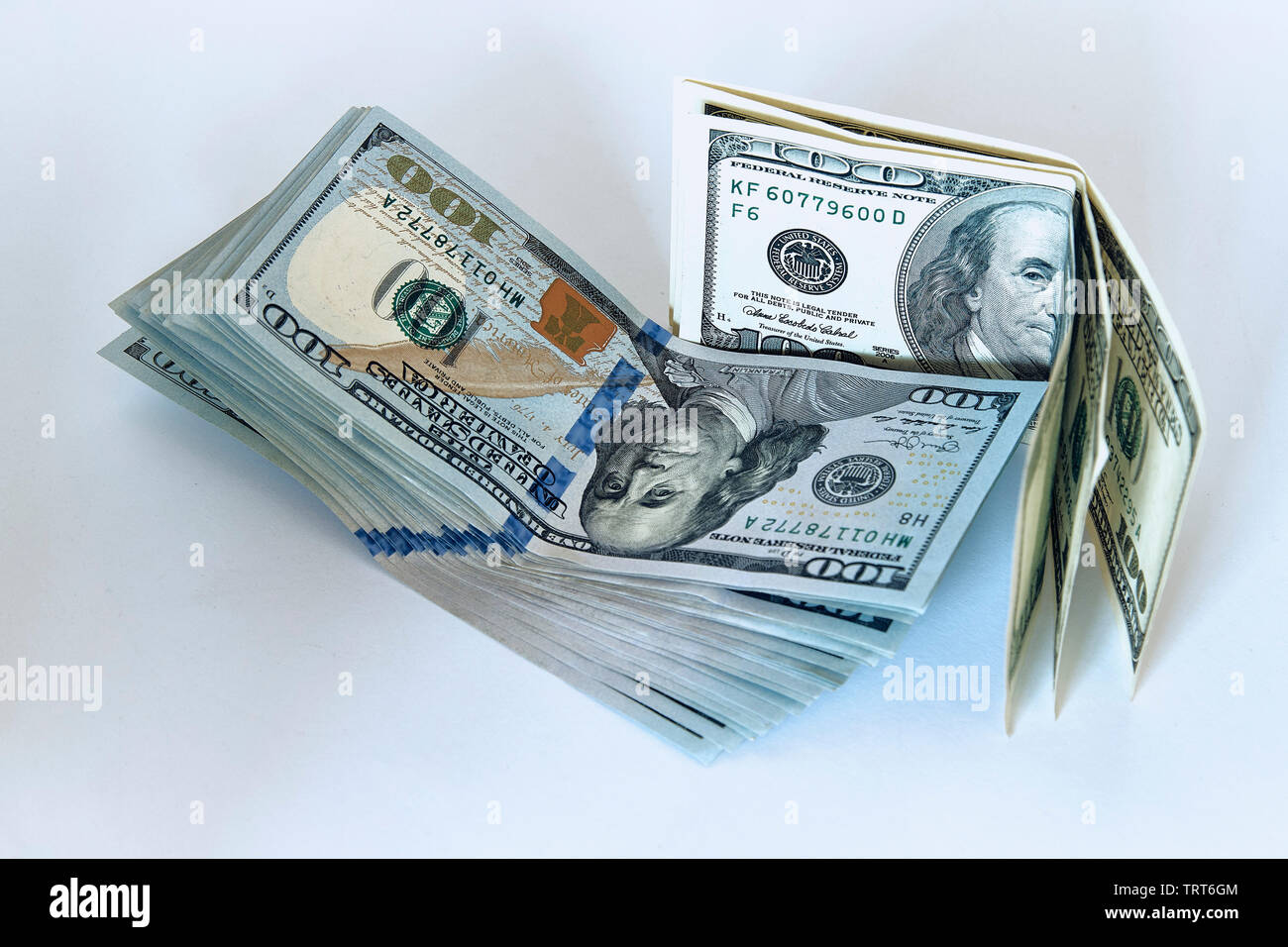 Stack of one hundred dollar bills new design on a white background ...