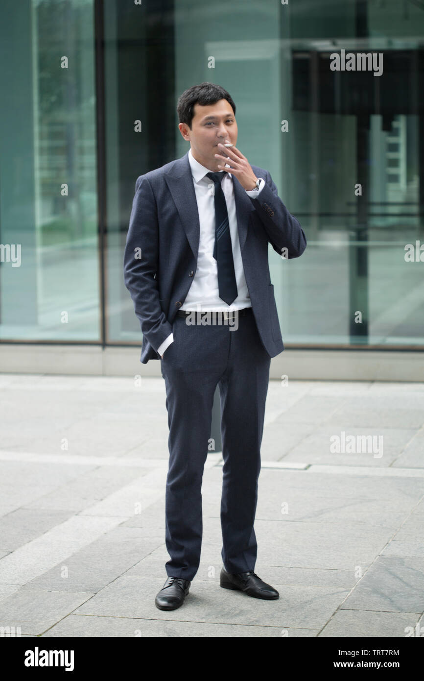 Asian businessman in black suit Stock Photo - Alamy