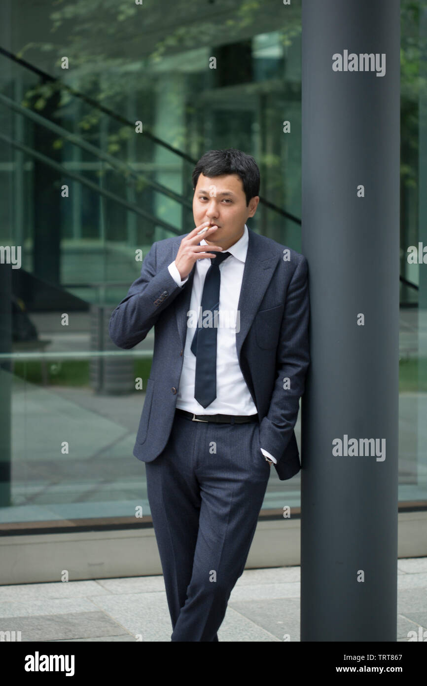 Asian businessman in black suit Stock Photo - Alamy
