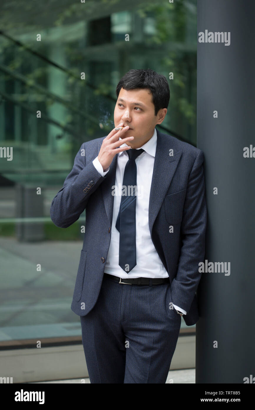 Chinese man in suit smoking hi-res stock photography and images - Alamy